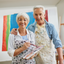 Senior couple in an art studio with painting supplies