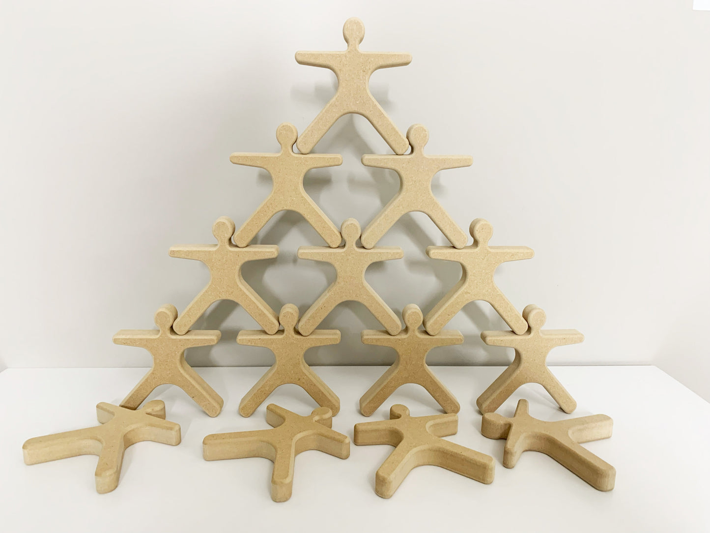 Wooden cutout figures stacked in a pyramid shape activity for seniors