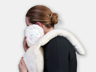 Person holding a large white plush hug doll