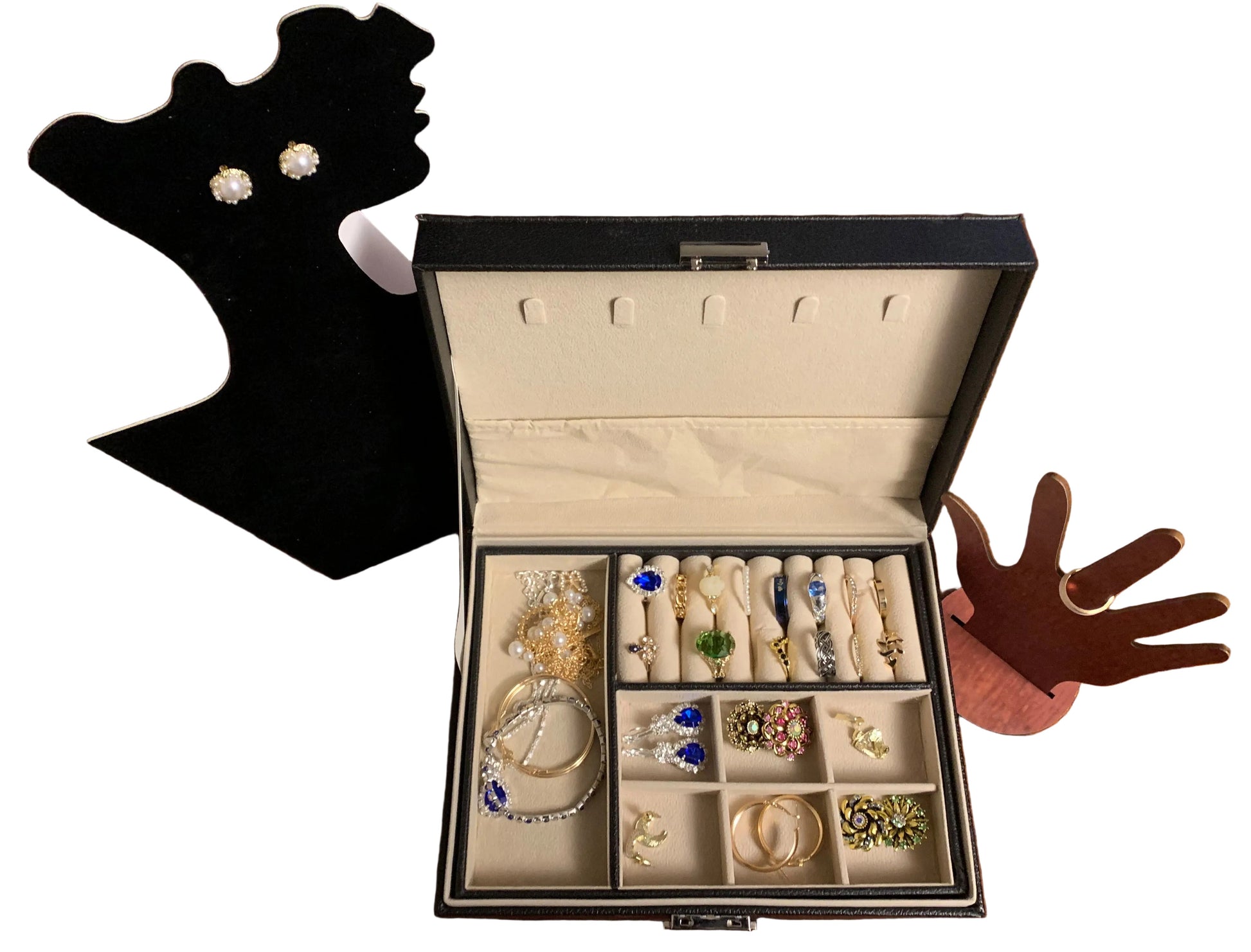 Open jewelry box with various earrings and jewels