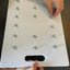 White board with multiple small holes to assemble nuts and bolts activity
