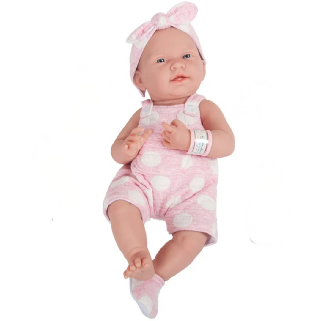 Baby Suzie Q doll in pink outfit with bow on head for memory care therapy