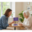 Caregiver holding golden memory conversation card