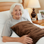 lady smiling with  ComfortCare Warming pad