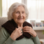 Elderly lady with HarmonyHeat Comfort shoulder wrap positioned around neck and shoulders 