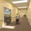 Elderly man in wheelchair and lady with walker walking away from camouflaged door mural