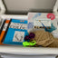 Art supplies including a book, paintbrush, and canvases relaxation and creativity