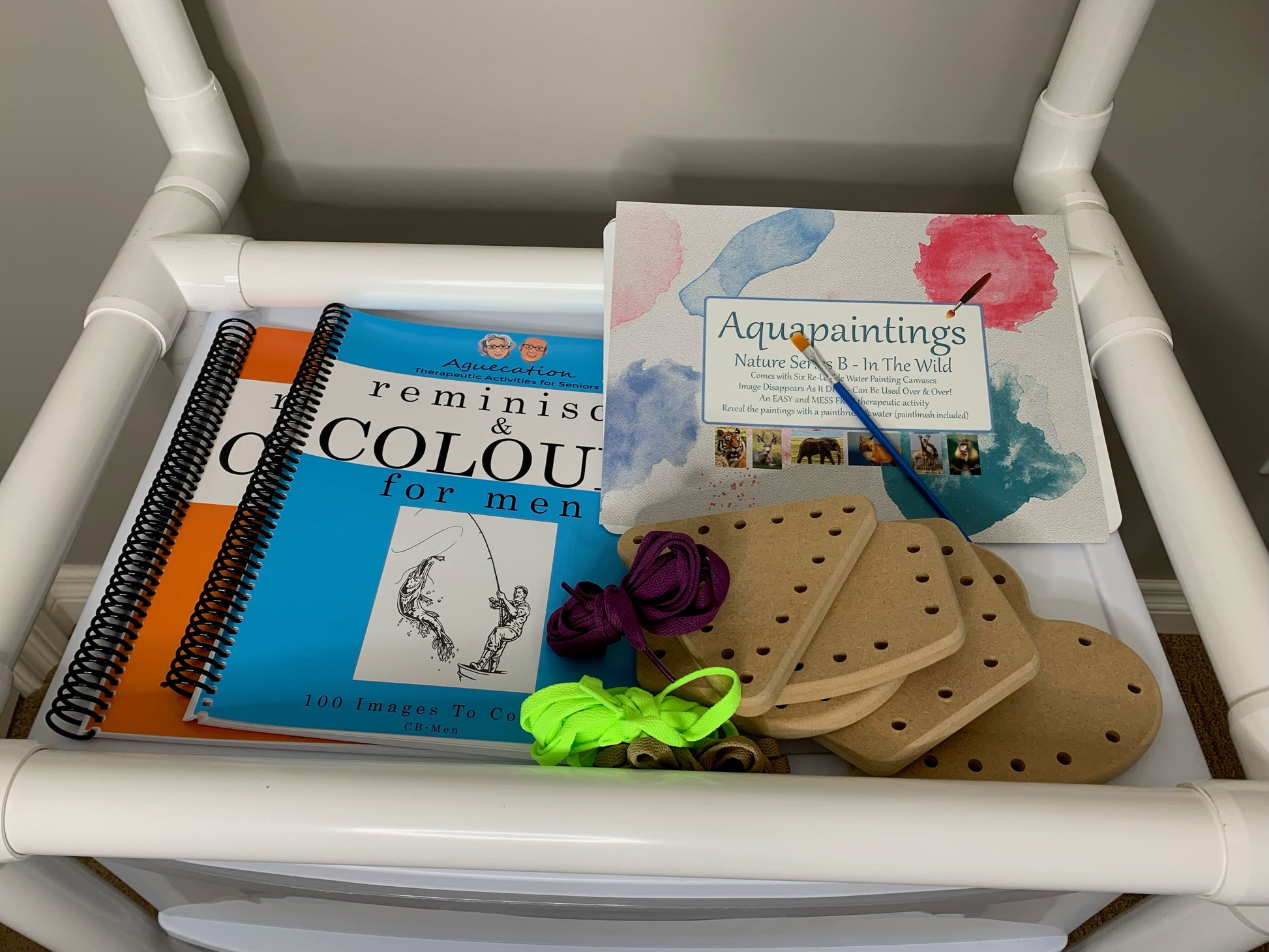 Art supplies including a book, paintbrush, and canvases relaxation and creativity