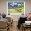 Multicultural seniors watching horse projection in care facility