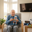 Senior male listening to radio, holding a therapy boy doll, playing with fidget