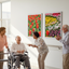 seniors laughing and pointing at flower artwork