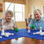 Seniors Playing Table Bowling with Knocked Down Pins
