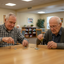 Two senior men playing with fidget tools