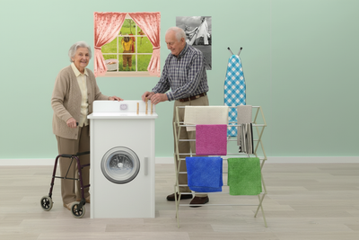 Two seniors using Laundry Life Skills Station
